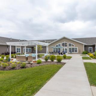 A welcoming residential community featuring beautifully landscaped gardens and pathways.