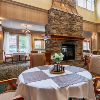 A cozy dining area with a stone fireplace and elegant table setting.