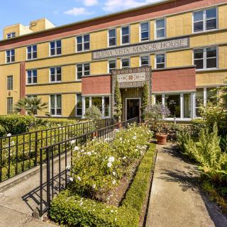A residential building with a garden pathway leading to the entrance.