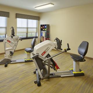 A gym room featuring specialized exercise equipment for rehabilitation and fitness.