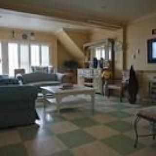 A spacious living room with comfortable furniture and natural light.