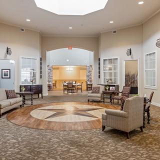 A spaciously designed living room with comfortable seating and elegant decor.