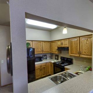 A cozy kitchen with wooden cabinets and modern appliances.