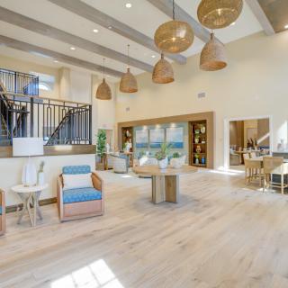 A spacious and modern lobby with natural light, featuring comfortable seating and stylish lighting.