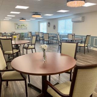 A spacious and well-lit dining area with elegant furniture, perfect for social gatherings.