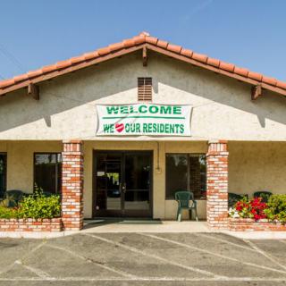 A small building with a welcome sign above the entrance.