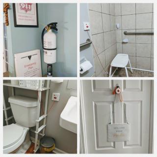 An accessible bathroom equipped with safety features such as a shower chair, handrails, and a fire extinguisher.