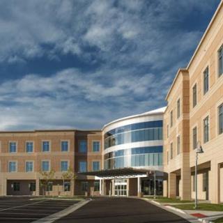 A modern healthcare facility featuring a blend of brick and glass architecture.