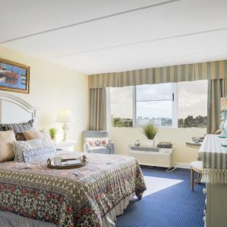 A bright and cozy bedroom with natural light streaming through the window.