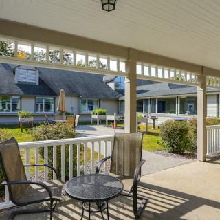 A cozy porch with seating overlooking a garden area, providing a peaceful outdoor retreat.