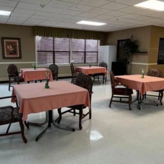 A quiet dining area with several tables and chairs arranged in a clean, well-lit space.