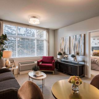 A cozy living room with modern furniture, ample natural light, and tasteful decor.