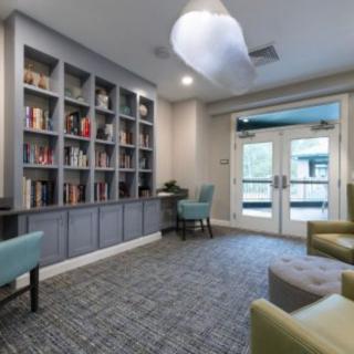 A modern library space with bookshelves and comfortable seating.