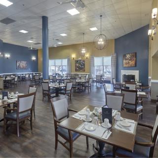 A modern restaurant dining area with neatly arranged tables and elegant decor.