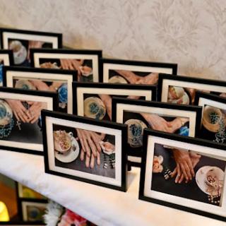 A showcase of beautifully framed photos capturing moments involving hands, elegantly displayed at an event.