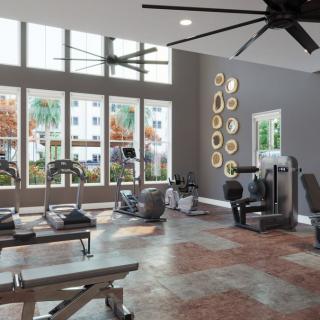 A modern gym with exercise equipment and large windows.