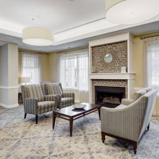 A cozy living room featuring comfortable seating, a fireplace, and stylish decor.
