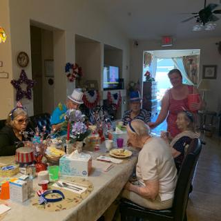 Seniors enjoying a festive gathering with decorations and shared activities.
