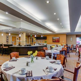 A modern restaurant dining area with neatly arranged tables and chairs.