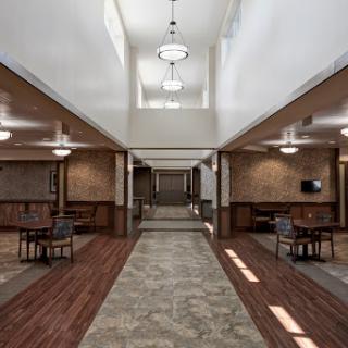 A spacious and well-lit lobby featuring modern design elements and comfortable seating.