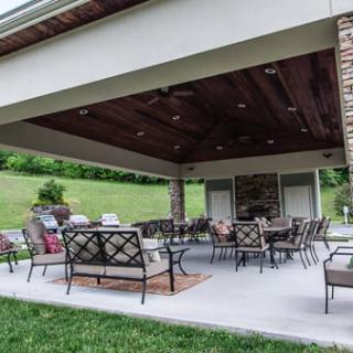 A spacious covered patio with elegant outdoor furniture, perfect for relaxation and gatherings.