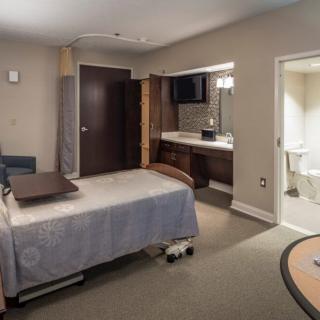 A modern and clean hospital room equipped with medical facilities.