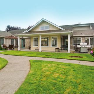 A single-story house with a well-maintained front lawn and walkway.