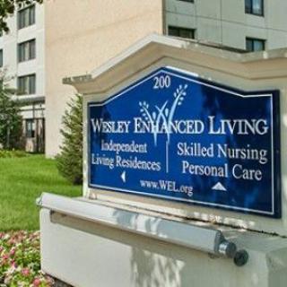 Sign for Welsey Enhanced Living, indicating independent living, skilled nursing, and personal care services.