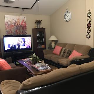 A cozy living room with comfortable sofas and a television.