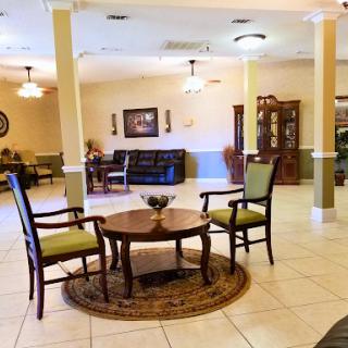 A cozy and inviting lobby area with comfortable seating and a central table.