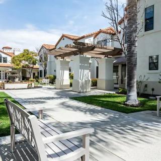 A serene courtyard in a residential area with benches and well-maintained pathways.