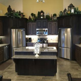 Modern kitchen interior with stainless steel appliances and an island counter.