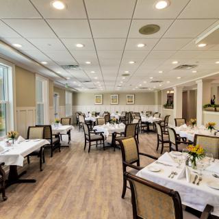 A spacious and elegantly designed restaurant dining area with neatly arranged tables and chairs.