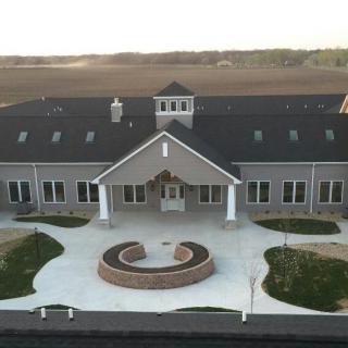 An aerial view of a modern building set in a rural landscape.