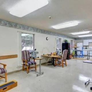 An organized office space with desks, chairs, and equipment.