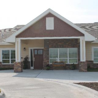 A suburban house with a brick exterior and large windows.