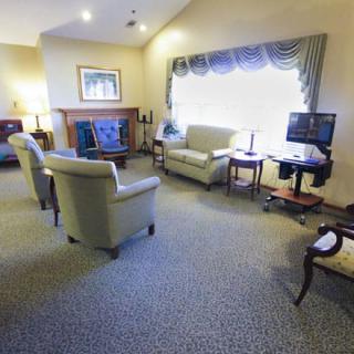 A cozy living room featuring comfortable seating, a fireplace, and a television.