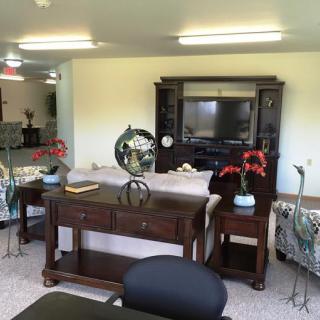 A comfortable living room with a sofa, television, and decorative elements.