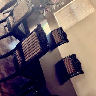 A set of wooden chairs around a dining table.