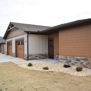 A modern residential house with a stone facade and attached garage.