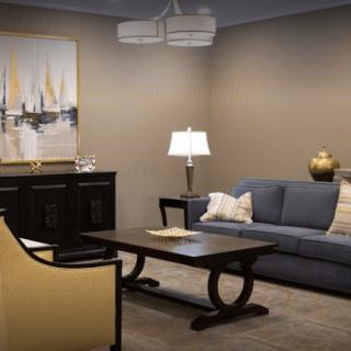A cozy living room with a stylish sofa, elegant table, and decorative artwork.