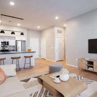 A modern open-concept living room and kitchen area with stylish furniture and decor.