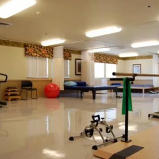 A rehabilitation room equipped with various physical therapy tools and exercise equipment.