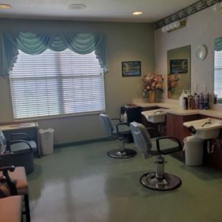 An empty hair salon with styling chairs and mirrors.