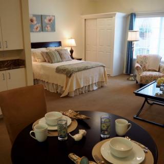 A cozy and elegantly decorated bedroom with a dining area.
