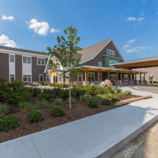 A modern community center featuring landscaped gardens and a welcoming entrance.