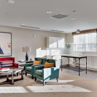 A modern living room with stylish furniture and large windows allowing natural light.