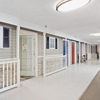 A clean and well-lit corridor with multiple doors.