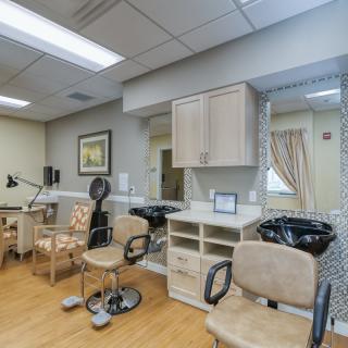 A well-equipped salon with chairs, mirrors, and hairdressing stations.