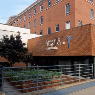 The entrance of a modern healthcare facility, showcasing its contemporary brick design and clear signage.
